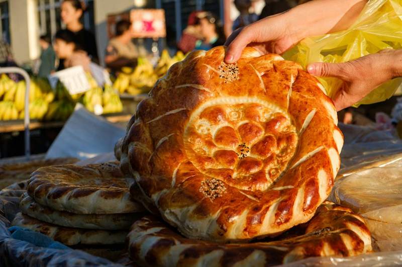 Pazar tezgâhında desenli, parlak yüzeyli yuvarlak Özbek nanları